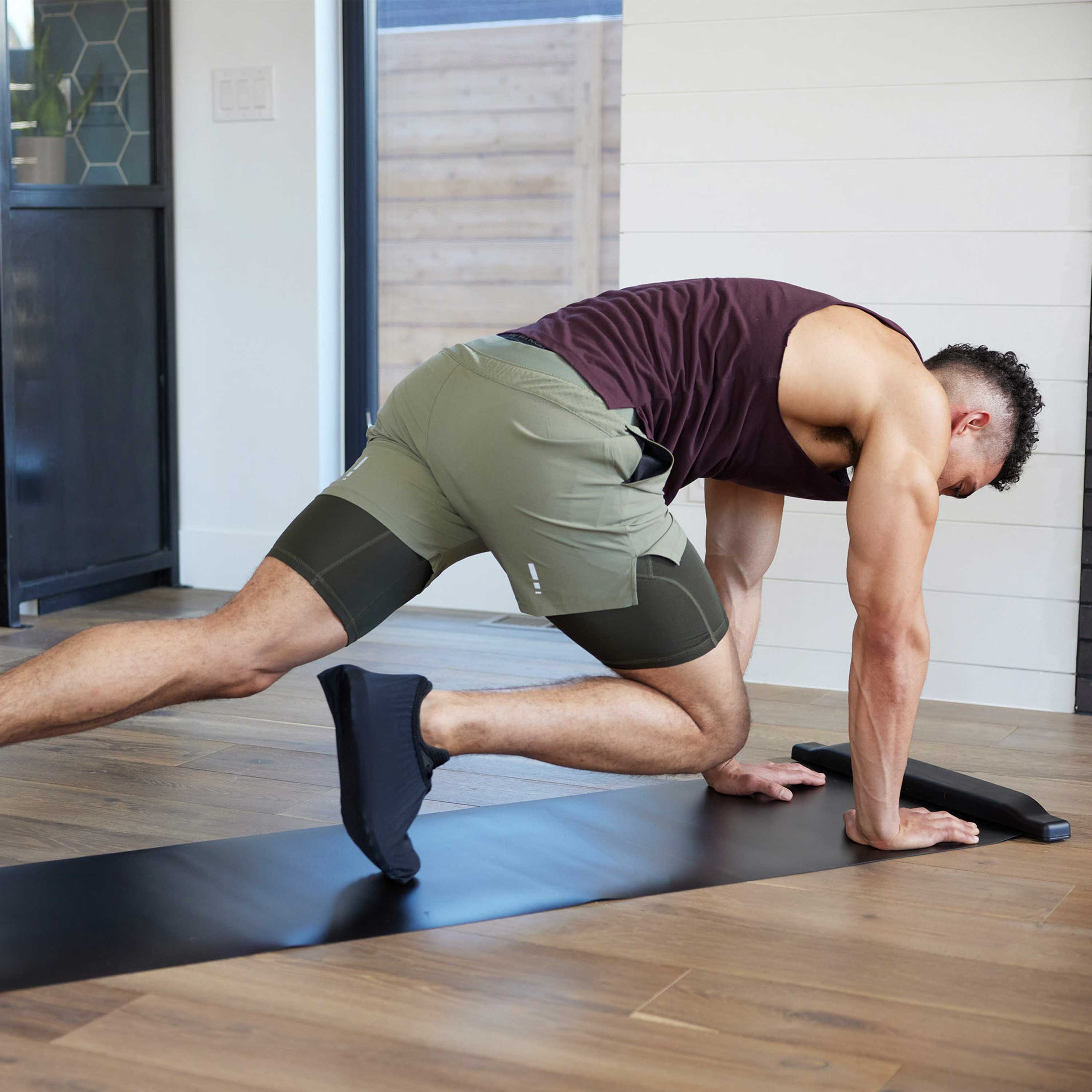 Person doing mountain climbers on the SPRI Slide Board